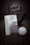 Golf ball and metal tracking dots on a textured surface with JP Golf branding.