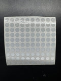 A sheet of white club data dots intended for use with a golf launch monitor, arranged in a pattern resembling a grid.