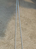 a pair of reflective alignment stick on a beige carpet floor. 