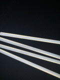 foresight foldable alignment stick reflecting under a light on a black background. 