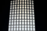 A sheet of reflective dots designed for use with golf launch monitors, arranged in rows.