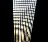A roll of reflective silver dots arranged in a grid pattern on a transparent background.