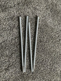 A foldable reflective alignment stick for golf, displayed on a textured surface.